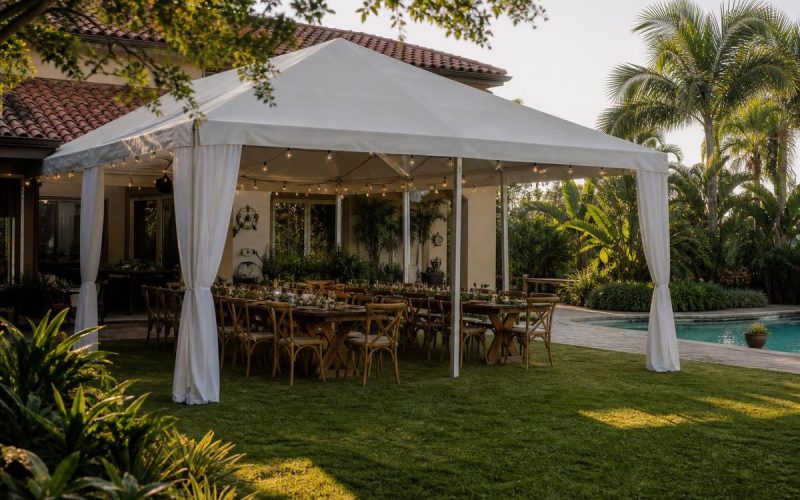 White frame tent over farm-table dinner in a Florida estate backyard by the pool
