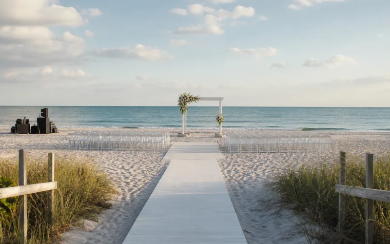 Gulf Coast beach ceremony setup with a stable aisle, weighted structure and organized equipment access